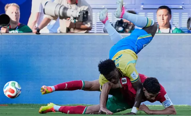 Brazil's Vinicius Junior, top, and Morocco's Achraf Hakimi battle for the ball during the World Cup Group C soccer match between Brazil and Morocco in East Rutherford, N.J., near New York, Saturday, June 13, 2026. (AP Photo/Petr David Josek)