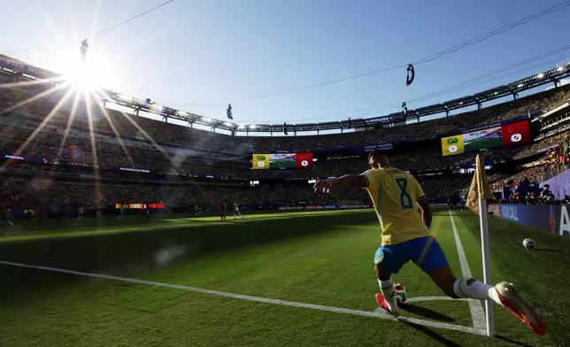 Brazil's Bruno Guimaraes (8) takes a corner kick in the first half during the World Cup Group C soccer match between Brazil and Morocco in East Rutherford, N.J., near New York, Saturday, June 13, 2026. (AP Photo/Adam Hunger)