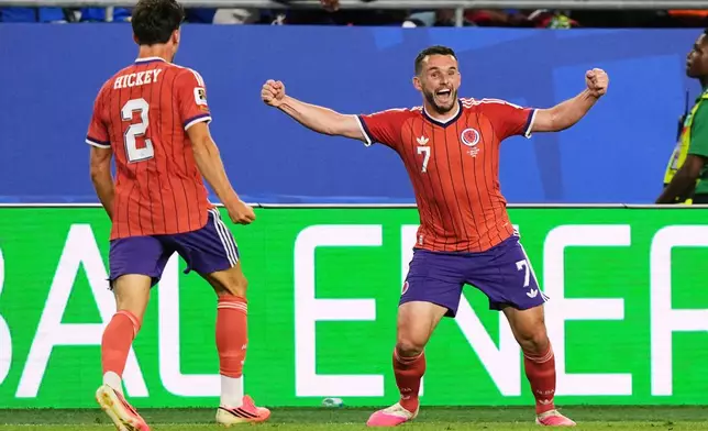 Scotland's John McGinn (7) celebrates with teammate Aaron Hickey (2) after scoring his teams first goal during the World Cup Group C soccer match between Haiti and Scotland in Foxborough, Mass., near Boston, Saturday, June 13, 2026. (AP Photo/Martin Meissner)