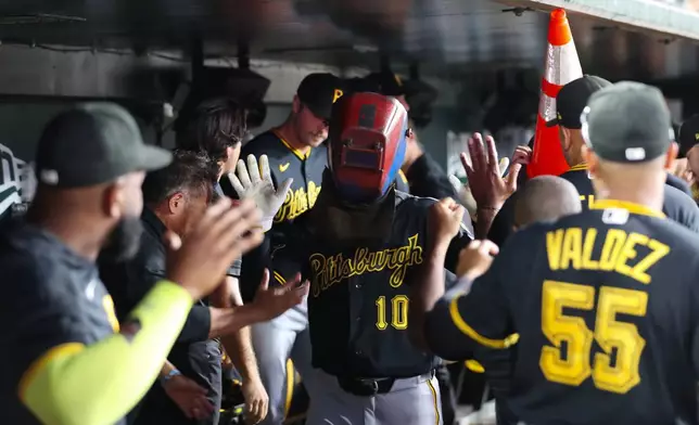 Pittsburgh Pirates' Bryan Reynolds (10) celebrates in the dugout with his teammates after hitting a two run during the seventh inning of a baseball game against the Athletics Tuesday, June 16, 2026, in West Sacramento, Calif. (AP Photo/Scott Marshall)