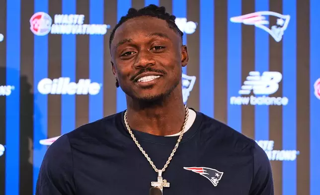 New England Patriots wide receiver A.J. Brown smiles during a media availability following an NFL football practice, Tuesday, June 2, 2026, in Foxborough, Mass. (AP Photo/Charles Krupa)