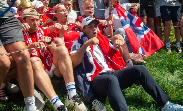 Viktor Hovland celebrates his victory with fellow Norwegians as they do the Viking Row on the 18th green after winning a playoff at the 2026 Travelers Championship at TPC River Highlands in Cromwell, Conn., Monday, June 29, 2026. (Aaron Flaum/Hartford Courant via AP)