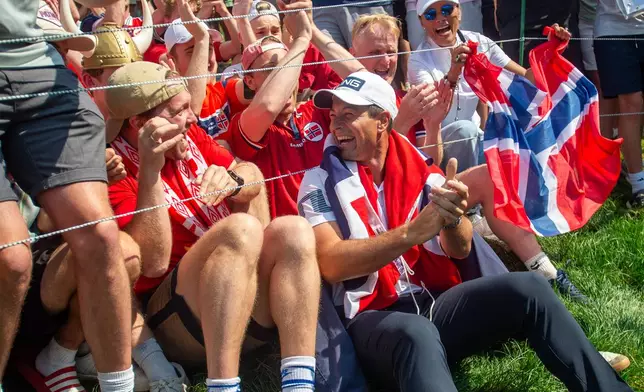 Viktor Hovland celebrates his victory with fellow Norwegians as they do the Viking Row on the 18th green after winning a playoff at the 2026 Travelers Championship at TPC River Highlands in Cromwell, Conn., Monday, June 29, 2026. (Aaron Flaum/Hartford Courant via AP)