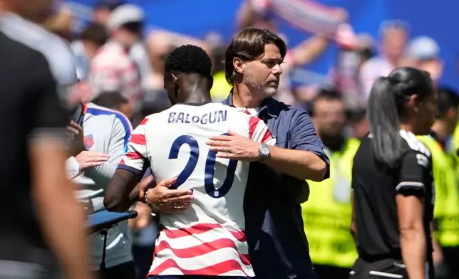 United States head coach Mauricio Pochettino embraces United States' Folarin Balogun after he was substituted during the World Cup Group D soccer match between the United States and Australia in Seattle, Friday, June 19, 2026. (AP Photo/Lindsey Wasson)