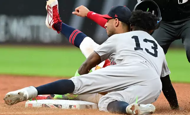 New York Yankees' Jazz Chisholm Jr. collides with Cleveland Guardians shortstop Brayan Rocchio after being tagged out at second base attempting to steal during the sixth inning of a baseball game, Monday, June 8, 2026, in Cleveland. (AP Photo/David Dermer)