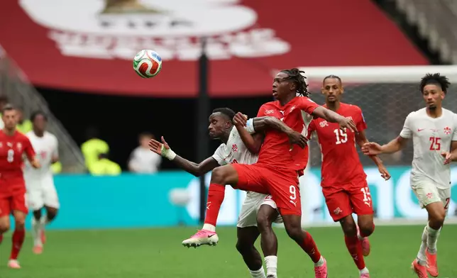 Canada's Richie Laryea (22) and Switzerland's Johan Manzambi (9) compete for the ball during the World Cup Group B soccer match between Switzerland and Canada in Vancouver, British Columbia, Wednesday, June 24, 2026. (AP Photo/Sydney Shankman)