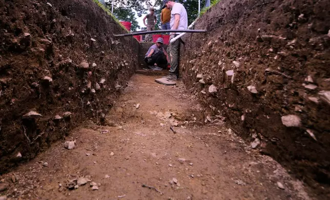Joe Bagley, right, the City of Boston Archeologist, talks with with Sarah Kiley Schoff, a forensic anthropologist, during an archaeological dig at the site of the Battle of Bunker Hill, Monday, June 15, 2026, in Boston. (AP Photo/Charles Krupa)