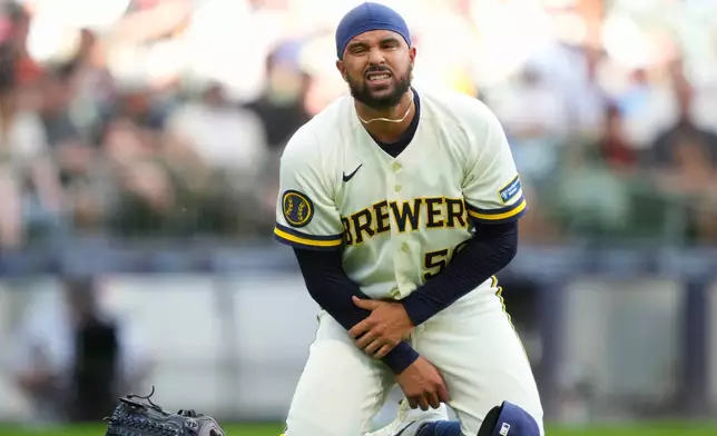 Milwaukee Brewers pitcher Grant Anderson reacts after being hit by a batted ball during the seventh inning of a baseball game against the San Francisco Giants, Thursday, June 4, 2026, in Milwaukee. (AP Photo/Kayla Wolf)
