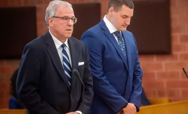 Former Hartford police officer Joseph Magnanom, right, stands with his attorney, Patrick Tomasiewicz, during his arraignment at Hartford Superior Court in Hartford, Conn., on Friday, June 5, 2026. (Aaron Flaum/Hartford Courant via AP, Pool)