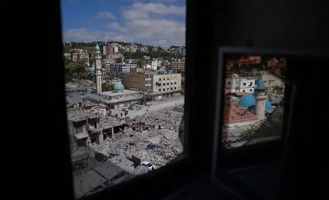 Lebanese Shiites take part in an Ashoura procession amid buildings destroyed by Israeli strikes, when Shiites commemorate the martyrdom of Imam Hussein, the grandson of the Prophet Muhammad, in Nabatiyeh, southern Lebanon, Friday, June 26, 2026. (AP Photo/Hassan Ammar)