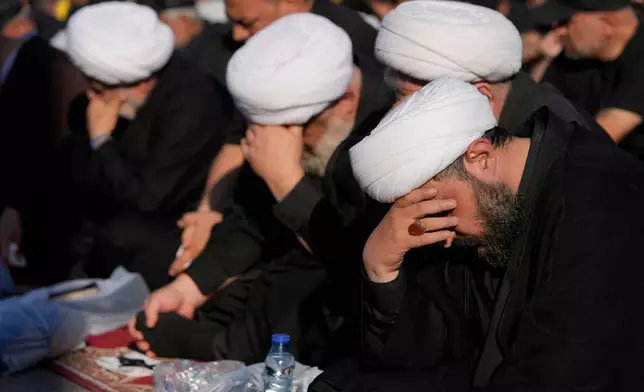 Hezbollah cleric mourn as they listen to the death story of Imam Hussein during the holy day of Ashoura that commemorates the 7th century martyrdom of the Prophet Muhammad's grandson Hussein, in Dahiyeh, Beirut's southern suburbs, Lebanon, Friday, June 26, 2026. (AP Photo/Hussein Malla)