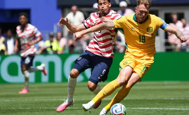 United States' Ricardo Pepi (9) and Australia's Harry Souttar (19) fight for the ball during the World Cup Group D soccer match between the United States and Australia in Seattle, Friday, June 19, 2026. (AP Photo/Ted S. Warren)