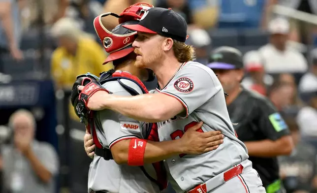 Washington Nationals catcher Keibert Ruiz, left, and pitcher Clayton Beeter, right, celebrate after their win over the Tampa Bay Rays in a baseball game Saturday, June 20, 2026, in St. Petersburg, Fla. (AP Photo/Jason Behnken)