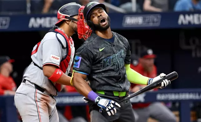 Tampa Bay Rays' Cedric Mullins, right, reacts after striking out during the ninth inning of a baseball game against the Washington Nationals, Saturday, June 20, 2026, in St. Petersburg, Fla. (AP Photo/Jason Behnken)