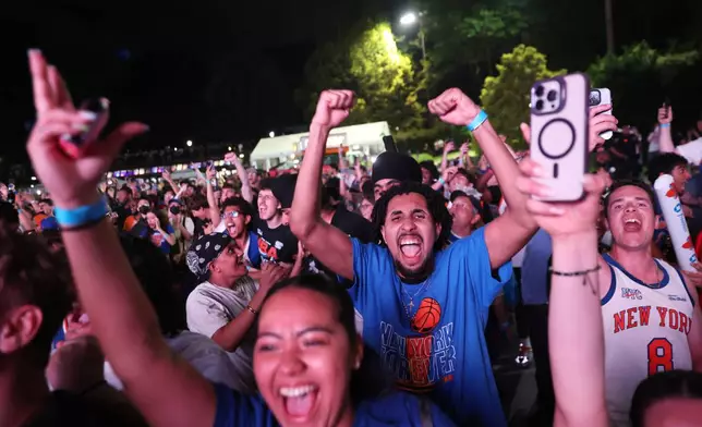 New York Knicks fans celebrate during a watch party inside Central Park during Game 4 of the NBA Finals basketball series between the Knicks and the San Antonio Spurs, Wednesday, June 10, 2026, in New York. (AP Photo/Heather Khalifa)