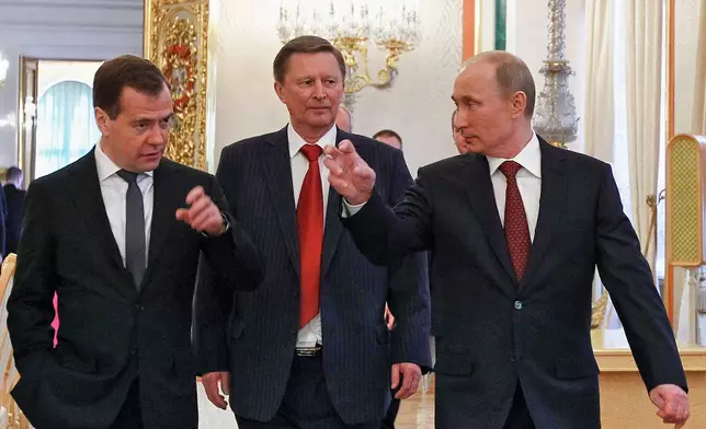 FILE - Russian Premier Dmitry Medvedev, left, Deputy Premier Sergei Ivanov, center, and Russian President Vladimir Putin walk after a state-of-the nation address in Moscow, Russia, Wednesday, Dec. 12, 2012. (AP Photo/Misha Japaridze, File)