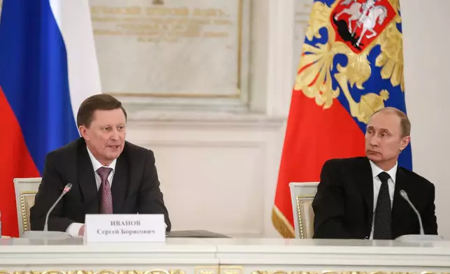 FILE - Russian President Vladimir Putin, right, and Kremlin's Chief of Staff Sergei Ivanov attend a meeting of the V-Day celebrations organizing committee in the Kremlin in Moscow, Russia, Tuesday, March 17, 2015. (AP Photo/Sergei Ilnitsky, Pool, File)