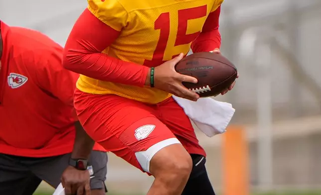 Kansas City Chiefs quarterback Patrick Mahomes participates in a drill during the NFL football team's practice Wednesday, June 3, 2026, in Kansas City, Mo. (AP Photo/Charlie Riedel)