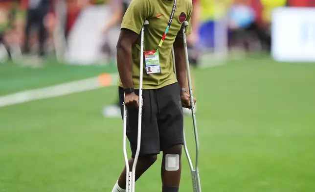 Canada's Ismael Kone, who broke his leg in a match against Qatar on June 18, watches teammates warm up before the World Cup Group B soccer match between Switzerland and Canada in Vancouver, British Columbia, Wednesday, June 24, 2026. (Darryl Dyck/The Canadian Press via AP)