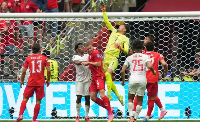 Switzerland goalkeeper Gregor Kobel (1) jumps to make a save during the World Cup Group B soccer match between Switzerland and Canada in Vancouver, British Columbia, Wednesday, June 24, 2026. (AP Photo/Abbie Parr)
