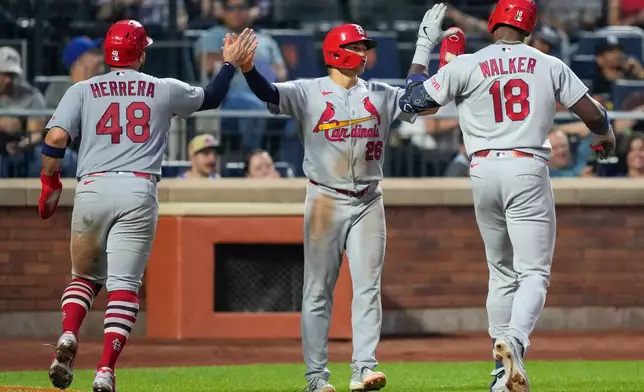 St. Louis Cardinals designated hitter Jordan Walker (18) celebrates with JJ Wetherholt (26), and Iván Herrera (48) after hitting a three run home run during the fourth inning of a baseball game against the New York Mets, Wednesday, June 10, 2026, in New York. (AP Photo/Yuki Iwamura)