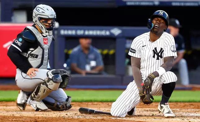 New York Yankees' Jazz Chisholm Jr., right, reacts after fouling a ball off himself during the fourth inning of a baseball game against the Chicago White Sox, Thursday, June 18, 2026, in New York. (AP Photo/Noah K. Murray)