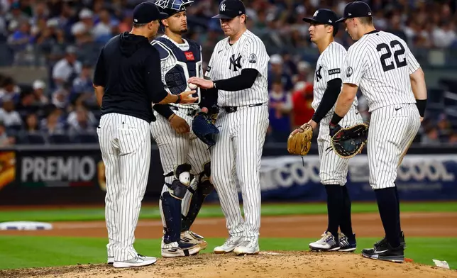 New York Yankees'manager Aaron Boone takes the ball from New York Yankees pitcher Ryan Weathers during the seventh inning of a baseball game against the Chicago White Sox, Thursday, June 18, 2026, in New York. (AP Photo/Noah K. Murray)