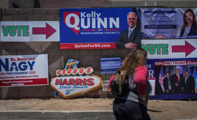 Campaign signs are display outside a vote center Tuesday, June 9, 2026, in Las Vegas. (AP Photo/Jae C. Hong)
