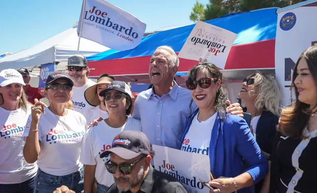 Nevada Gov. Joe Lombardo, center, poses with supporters outside a vote center Tuesday, June 9, 2026, in Las Vegas. (AP Photo/Jae C. Hong)