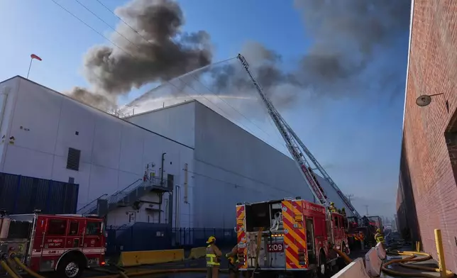 Crews work a warehouse fire in the Boyle Heights section of Los Angeles on Wednesday, June 17, 2026. (AP Photo/Jae C. Hong)