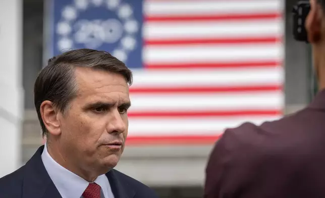Acting Attorney General Todd Blanche speaks to a reporter outside the White House, Wednesday, May 27, 2026, in Washington. (AP Photo/Mark Schiefelbein)