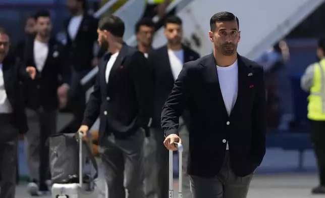 Iran's Ehsan Hajisafi, right, arrives with his teammates for the World Cup soccer tournament in Tijuana, Mexico, Sunday, June 7, 2026. (AP Photo/Gregory Bull)