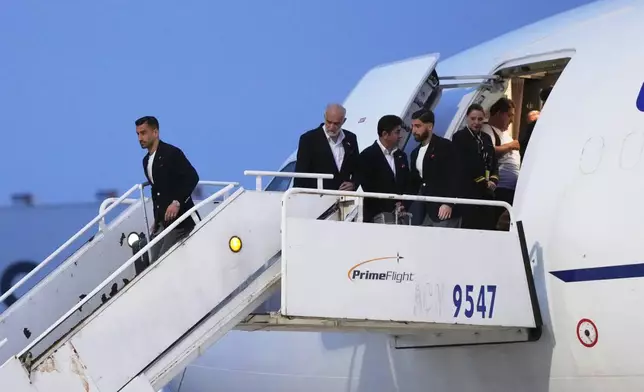Iran's Ehsan Hajisafi, left, arrives with his teammates for the World Cup soccer tournament in Tijuana, Mexico, Sunday, June 7, 2026. (AP Photo/Gregory Bull)