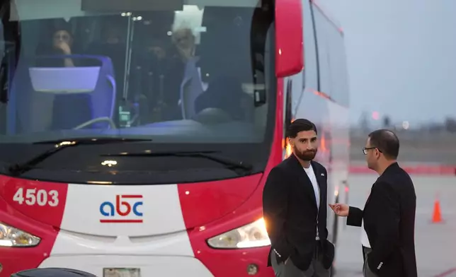Iran's Alireza Jahanbakhsh, second from right, talks with a team official as he arrives with his teammates for the World Cup soccer tournament in Tijuana, Mexico, Sunday, June 7, 2026. (AP Photo/Gregory Bull)