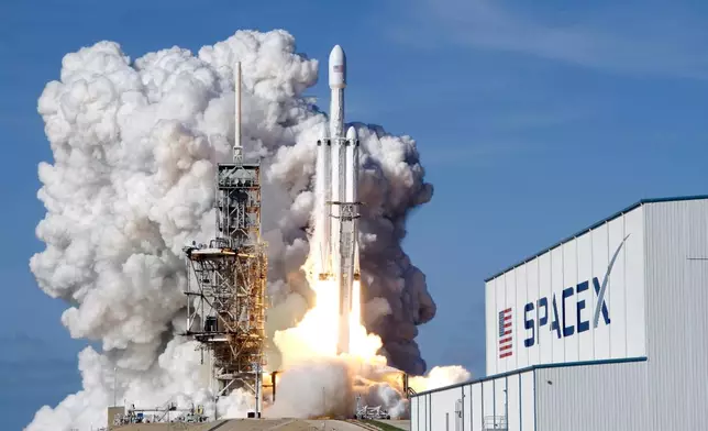 FILE - A Falcon 9 SpaceX heavy rocket lifts off from pad 39A at the Kennedy Space Center in Cape Canaveral, Fla., Tuesday, Feb. 6, 2018. (AP Photo/John Raoux, File)