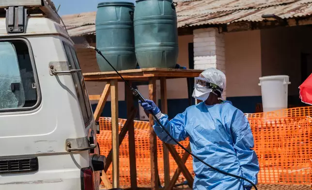 A health worker disinfects an ambulance at the Mongbwalu treatment center that transported a suspected Ebola patient in Mongbwalu, Congo, Friday, June 5, 2026. (AP Photo/Moses Sawasawa)