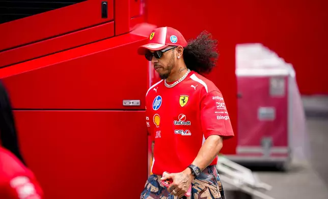Ferrari driver Lewis Hamilton of Britain walks at the Barcelona Catalunya racetrack in Montmelo, near Barcelona, Spain, Thursday, June 11, 2026. (AP Photo/ Joan Monfort)