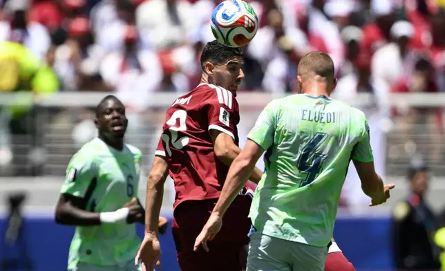 Switzerland's Nico Elvedi, right and Qatar's Karim Boudiaf, leap to head the ball during the World Cup Group B soccer match between Qatar and Switzerland in Santa Clara, Calif., near San Francisco, Saturday, June 13, 2026. (AP Photo/Eakin Howard)