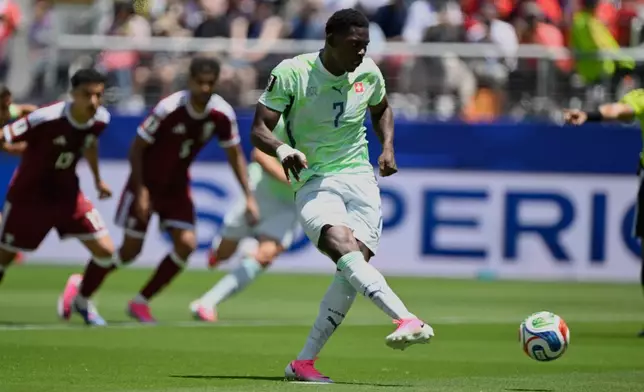 Switzerland's Breel Embolo shoot and scores the opening goal from the penalty spot during the World Cup Group B soccer match between Qatar and Switzerland in Santa Clara, Calif., near San Francisco, Saturday, June 13, 2026. (AP Photo/Eakin Howard)