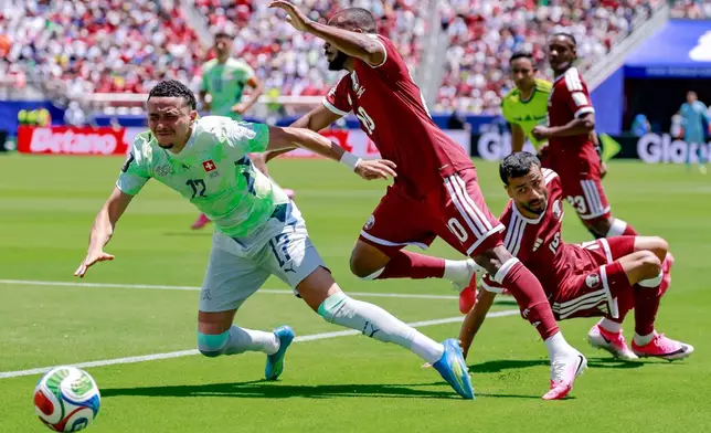 Switzerland's Ruben Vargas, left, in action against Qatar's Ahmed Fathy, right, during the World Cup Group B soccer match between Qatar and Switzerland in Santa Clara, Calif., near San Francisco, Saturday, June 13, 2026. (Peter Klaunzer, Keystone via AP)