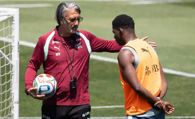 Switzerland's head coach Murat Yakin, left, talks to his player Breel Embolo during a training session for the national soccer team, Wednesday, June 10, 2026, in San Diego, ahead of the World Cup soccer tournament. (Peter Klaunzer/Keystone via AP)