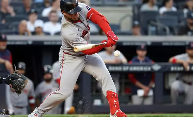 Boston Red Sox's Willson Contreras hits a run-scoring single during the third inning of a baseball game against the New York Yankees, Friday, June 5, 2026, in New York. (AP Photo/Adam Hunger)