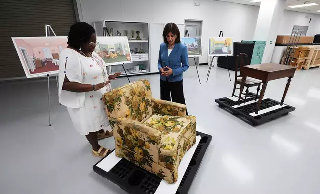 FILE - Amber N. Mitchell, Curator of Black History, left, and Patricia Mooradian, President and CEO of The Henry Ford, right, view items from the Jackson House, where Martin Luther King Jr. and others planned marches to call for Black voting rights in the early 60s in Selma, Ala., at The Henry Ford in Dearborn, Mich., July 14, 2025. (AP Photo/Paul Sancya, File)