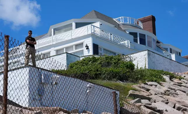 A security guard stands watch at Taylor Swift's "Holiday House," Saturday, June 20, 2026, in Westerly, R.I. (AP Photo/Robert F. Bukaty)