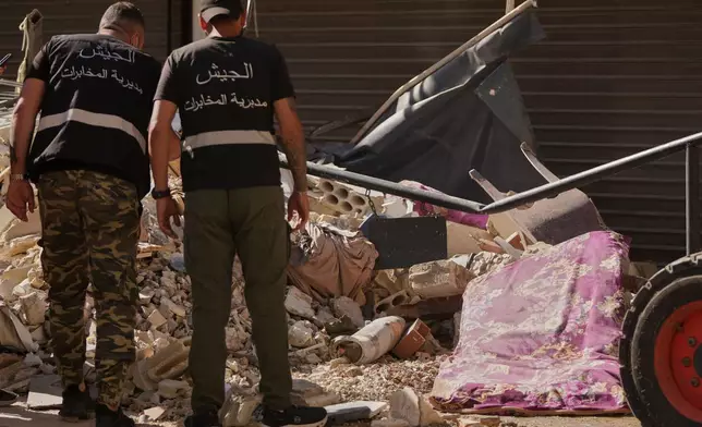 Lebanese intelligence officers look at an unexploded missile, centre, at the site where an Israeli airstrike hit a building in Dahiyeh, Beirut's southern suburb, Lebanon, Sunday, June 7, 2026. (AP Photo/Hassan Ammar)