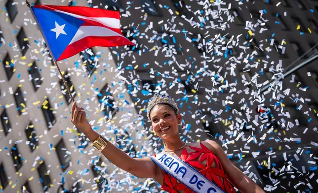 A person participates in the National Puerto Rican Day Parade, Sunday, June 14, 2026 in New York. (AP Photo/Adam Gray)