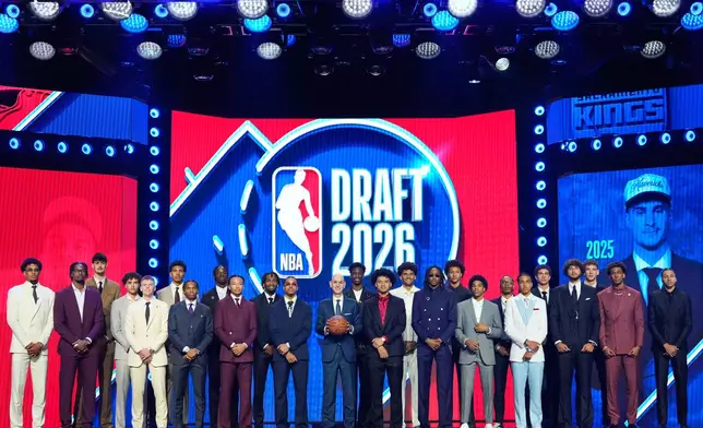 Prospective draftees pose for a group photo with NBA Commissioner Adam Silver, center, before the first round of the NBA basketball draft, Tuesday, June 23, 2026, in New York. (AP Photo/Yuki Iwamura)