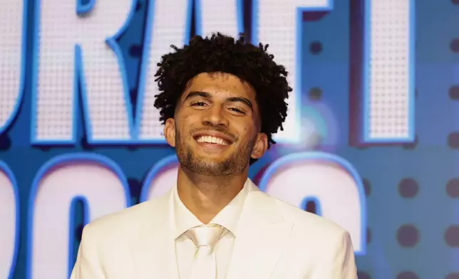 Cameron Boozer arrives for the first round of the NBA basketball draft Tuesday, June 23, 2026, in New York. (AP Photo/Adam Hunger)