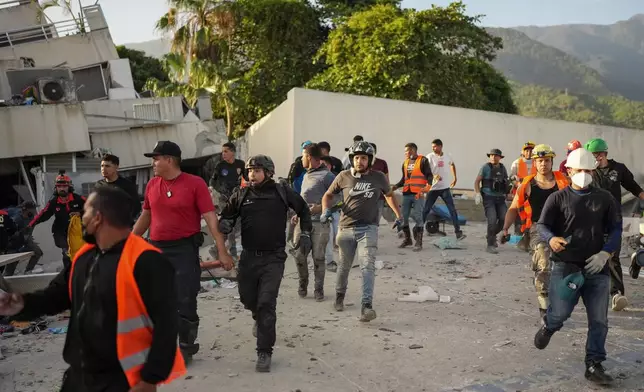 Residents and rescuers searching for survivors run as an aftershock shakes the area five days after back-to-back earthquakes struck La Guaira, Venezuela, Monday, June 29, 2026. (AP Photo/Matias Delacroix)