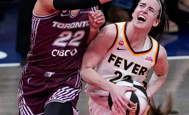 Indiana Fever guard Caitlin Clark, right, drives on Toronto Tempo guard Julie Allemand (22) in the first half of a WNBA Commissioner's Cup basketball game in Indianapolis, Tuesday, June 16, 2026. (AP Photo/Michael Conroy)